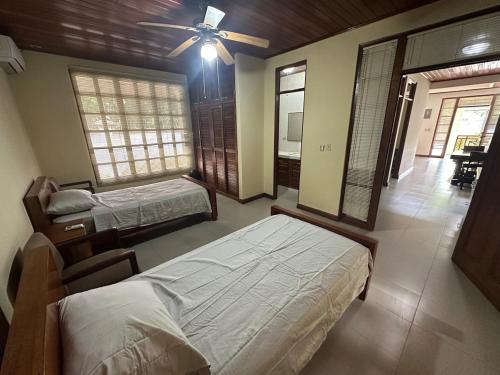 a bedroom with two beds and a ceiling fan at Full house, 2 Bedroom & kitchen in Bocas Town
