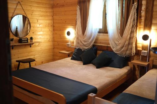 a bedroom with two beds in a wooden room at Jack Sparrow's cottage- Ada Bojana River in Donji Štoj