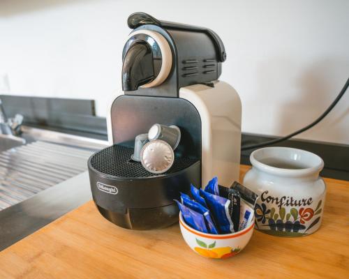 a coffee maker sitting on top of a table at Alojamento Da Cunha in Chaves