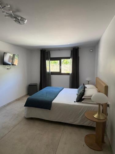 a bedroom with a large bed and a window at Kyrn Flor - Domaine Sant Antone in Corte