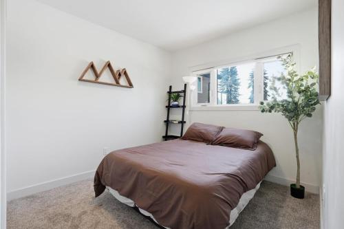 a bedroom with a bed and a window at Bright & Fully Renovated Retreat - Holiday Home in Saskatoon