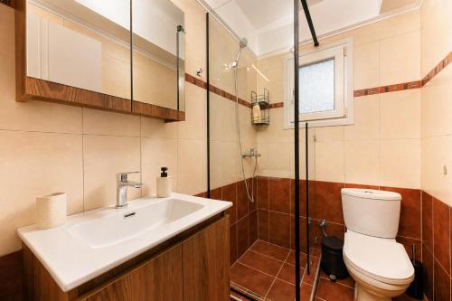 a bathroom with a sink and a toilet and a shower at VALLEY Premium House in Serres