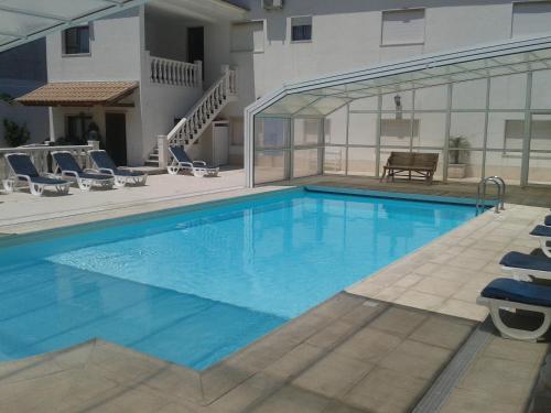 a large swimming pool with blue water in a building at Casas da Vila in Vimieiro