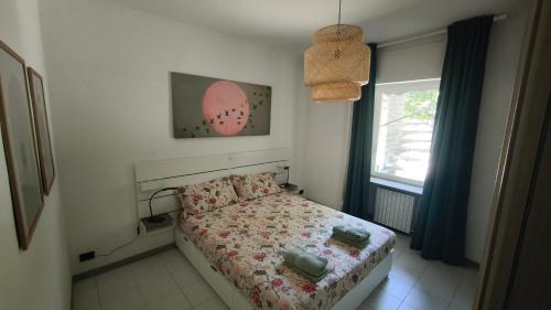 a small bedroom with a bed and a window at Al Piccolo Pontile Como lake in Mandello del Lario