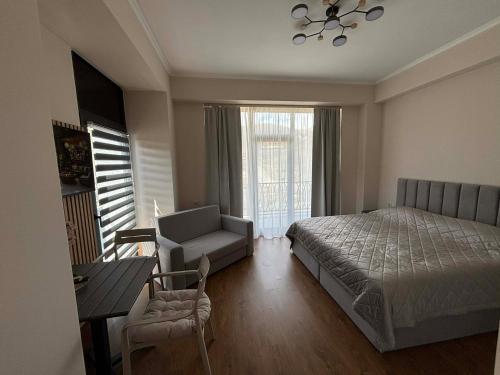 a bedroom with a bed and a table and a chair at Alvina 29 in Tsaghkadzor