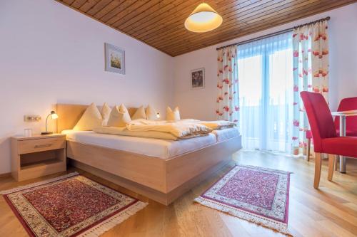 a bedroom with a bed and a large window at Haus Roswitha in Flachau