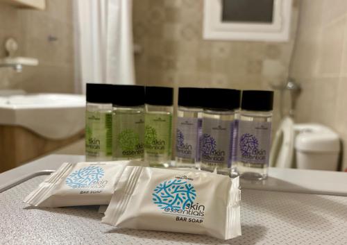 a group of four products sitting on a counter in a bathroom at Alimos Signature in Athens