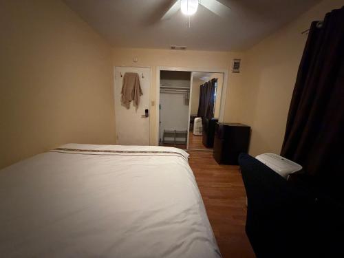 a bedroom with a bed and a door to a hallway at Citrus Loft - Quiet and convenient female only in Covina