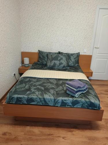 a bedroom with a bed with a wooden frame at Apartamenti dzīvoklis Ogre. in Ogre