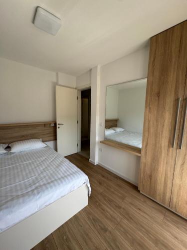 a bedroom with a bed and a large mirror at NMS Promet in Mrkonjić Grad