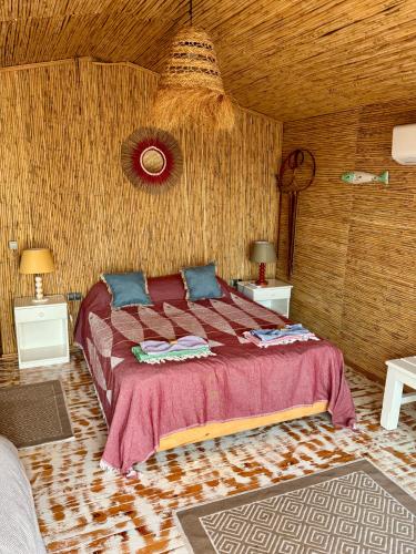 a bedroom with a bed and a wooden ceiling at Turan Hill Lounge in Faralya