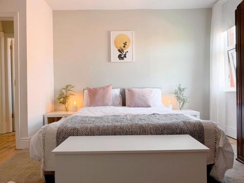 a bedroom with a large bed with two tables at Escape to Lytham St. Annes in Lytham St Annes