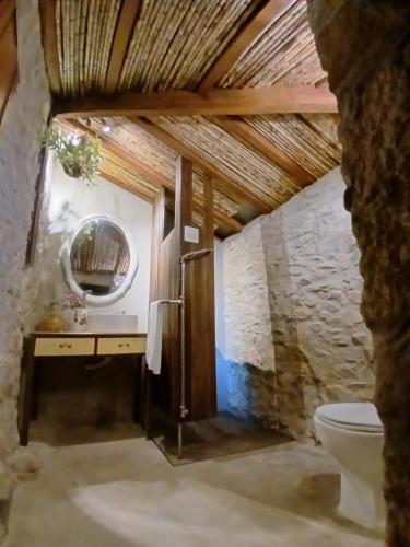 a bathroom with a sink and a mirror and a toilet at Esposende Garden in Esposende