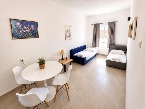 a living room with a table and a couch at Marika Seaside Apartments Drašnice Sea View, Parking & Near Beach in Drasnice