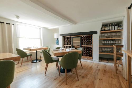 a dining room with a table and green chairs at Lion Cottage - Dog-Friendly 3-Bed in Heart of Holt in Holt