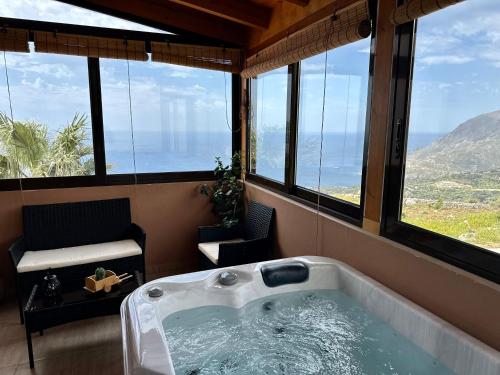 a large bath tub in a room with windows at Seaview Villa Liandroy in Sellía