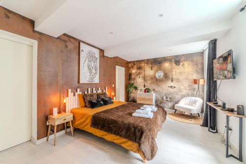 a bedroom with a large bed in a room at LOVE ROOM - Amour Chic et Intime in Montbrison