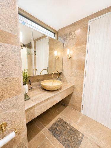 a bathroom with a sink and a large mirror at Green View Condo in Kathu