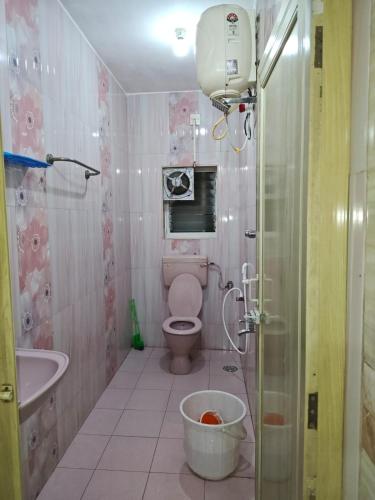 a bathroom with a toilet and a sink and a shower at Kanchi grace cottage in Kanchipuram