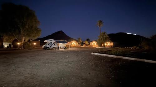 a car parked in a parking lot at night at Taragalte Park - Motorhomes in Zagora
