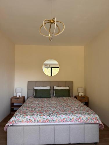 a bedroom with a large bed and a chandelier at Hil's Bay View - Terra in Lepetani