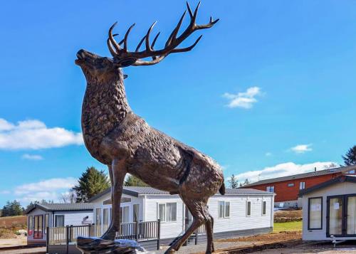 a statue of a deer with its head in the air at Benview Lodges in Kemnay