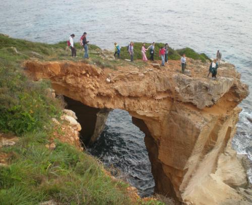 a group of people standing on a cliff near the ocean at Residencia Santiago Mallorca in Cala Figuera