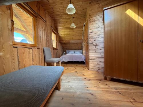 a bedroom with a bed in a wooden cabin at Domy z Bali nad jeziorem - Leśna Oaza in Międzyrzecz
