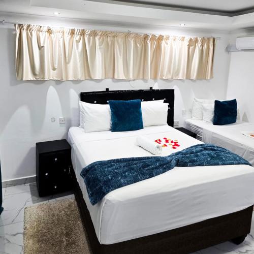 a bedroom with two beds with blue and white at Rest & Digest in Serowe