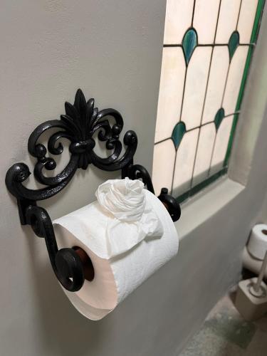 a roll of toilet paper on a holder in a bathroom at Greyton Stay in Greyton