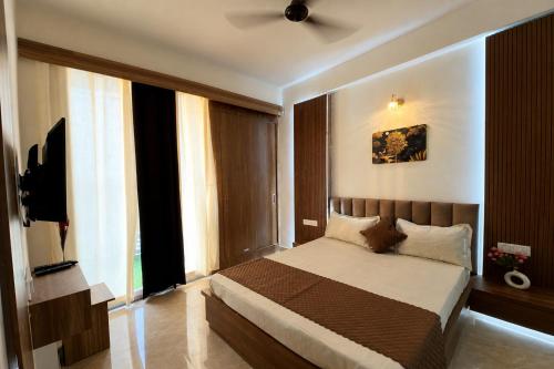 a bedroom with a bed with a ceiling fan at The Orion Nest in Noida
