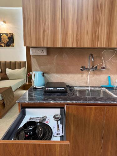 a kitchen with a stove top oven in a counter at The Orion Nest in Noida