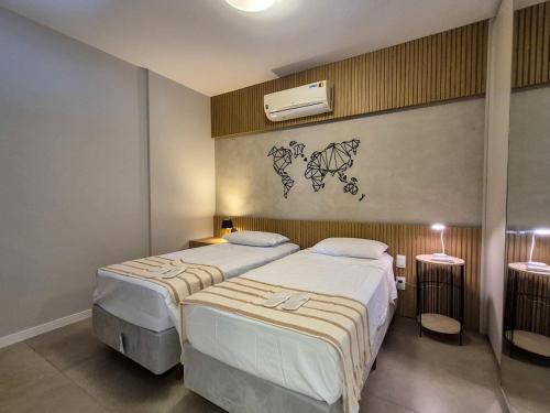 a bedroom with two beds and a wall at Apartment 13 - Jundiaí in Jundiaí