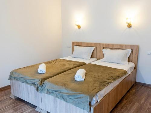 two beds in a room with two white beds at Mountain Horizon in Borjomi