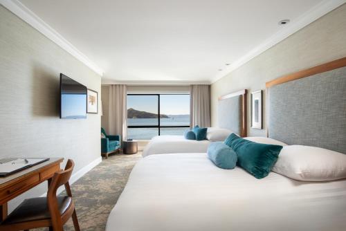 a hotel room with two beds and a desk at The Inn Above Tide in Sausalito