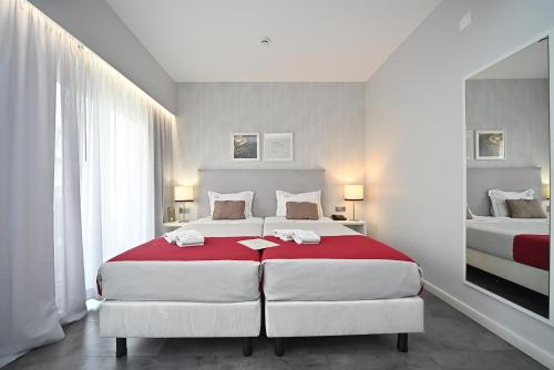 a bedroom with two beds with red and white sheets at My Charm Lisbon Suites in Lisbon