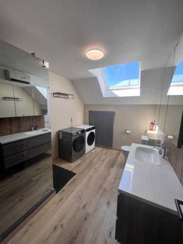 a large room with a kitchen with a sink and a window at Victoria Prestige Parking Gratuit in Boussu