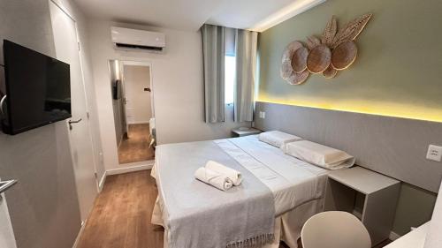 a hotel room with a bed with towels on it at Pousada Aquarela Do Brasil in Maceió