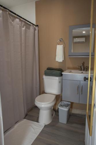 a bathroom with a toilet and a sink at Garden to Table Experience - Unit 101 in Rincon