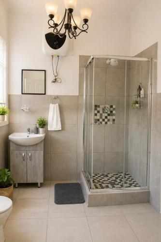 a bathroom with a shower and a sink at The Grace and Hope House in Bunkers Hill