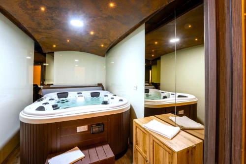 a bathroom with a large tub and two sinks at SILVER MOUNTAIN - ANA'S Apartments in Poiana Brasov