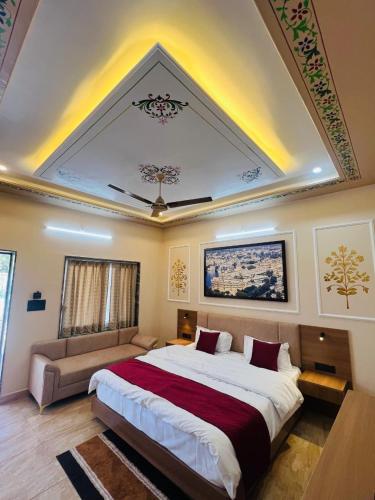 a bedroom with a large bed and a couch at Hotel Kalptaru Villas in Debāri