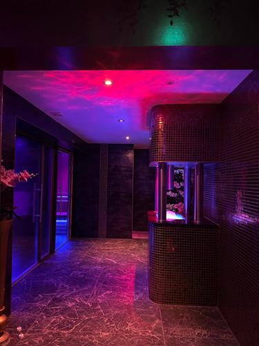 a room with purple and purple lights on the wall at Luxury Studios with Spa included in Portsmouth