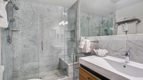 a bathroom with a shower and a sink and a toilet at Sea Crest in Amagansett