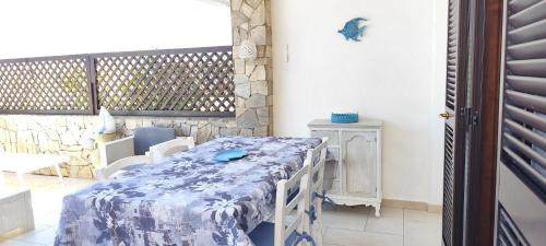 a table with a blue and white table cloth on a patio at Sardegna Top Golfo Di Marinella in Golfo Aranci