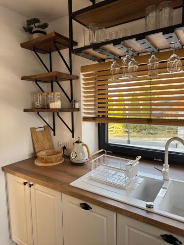 a kitchen counter with a sink and a window at Siedlisko in Tuchów