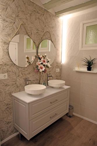 a bathroom with two sinks and a mirror at Casa Rural Garcés in Lumbier