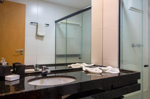 a bathroom with a sink and a mirror at Mana Beach Exclusive in Porto De Galinhas