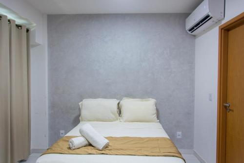 a bed in a room with two pillows on it at Mana Beach Exclusive in Porto De Galinhas