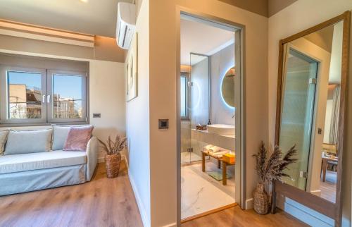 a living room with a couch and a mirror at Minotaur's Rest - Luxury Residences with Free Private Parking, near Port & Airport in Heraklio